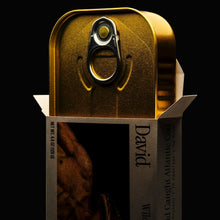 Gold canned fish with 'David' branding coming out of a box