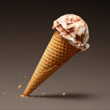 Frozen dessert scoop on a cone against a brown background